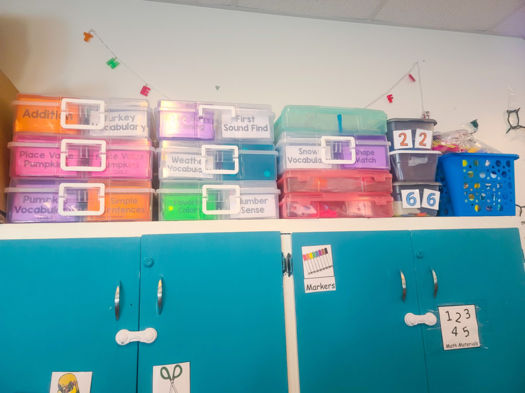Image of several multi-colored plastic containers full of educational activities.