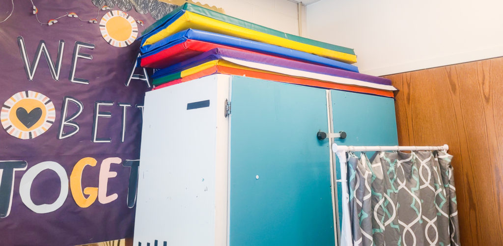 Top of a cabinet with colorful mats.