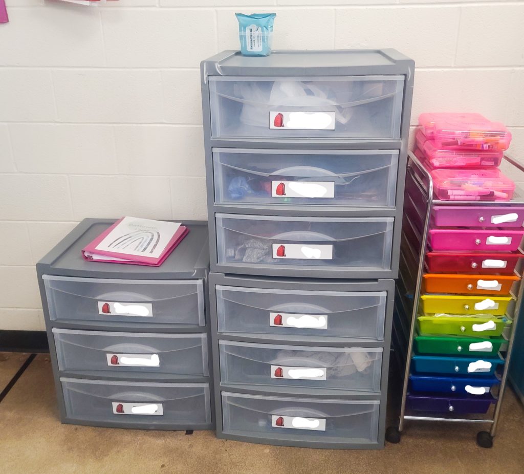 Plastic drawers with student name labels.