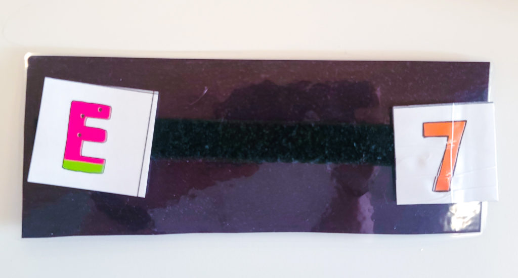 Black laminated rectangle with an E and a 7 on it.