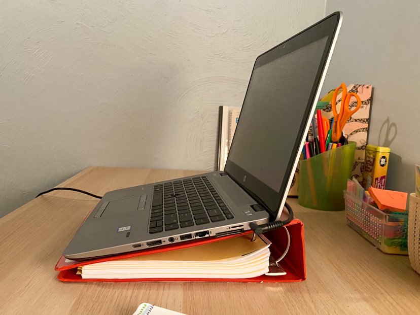 positioning accommodation: computer on a binder 