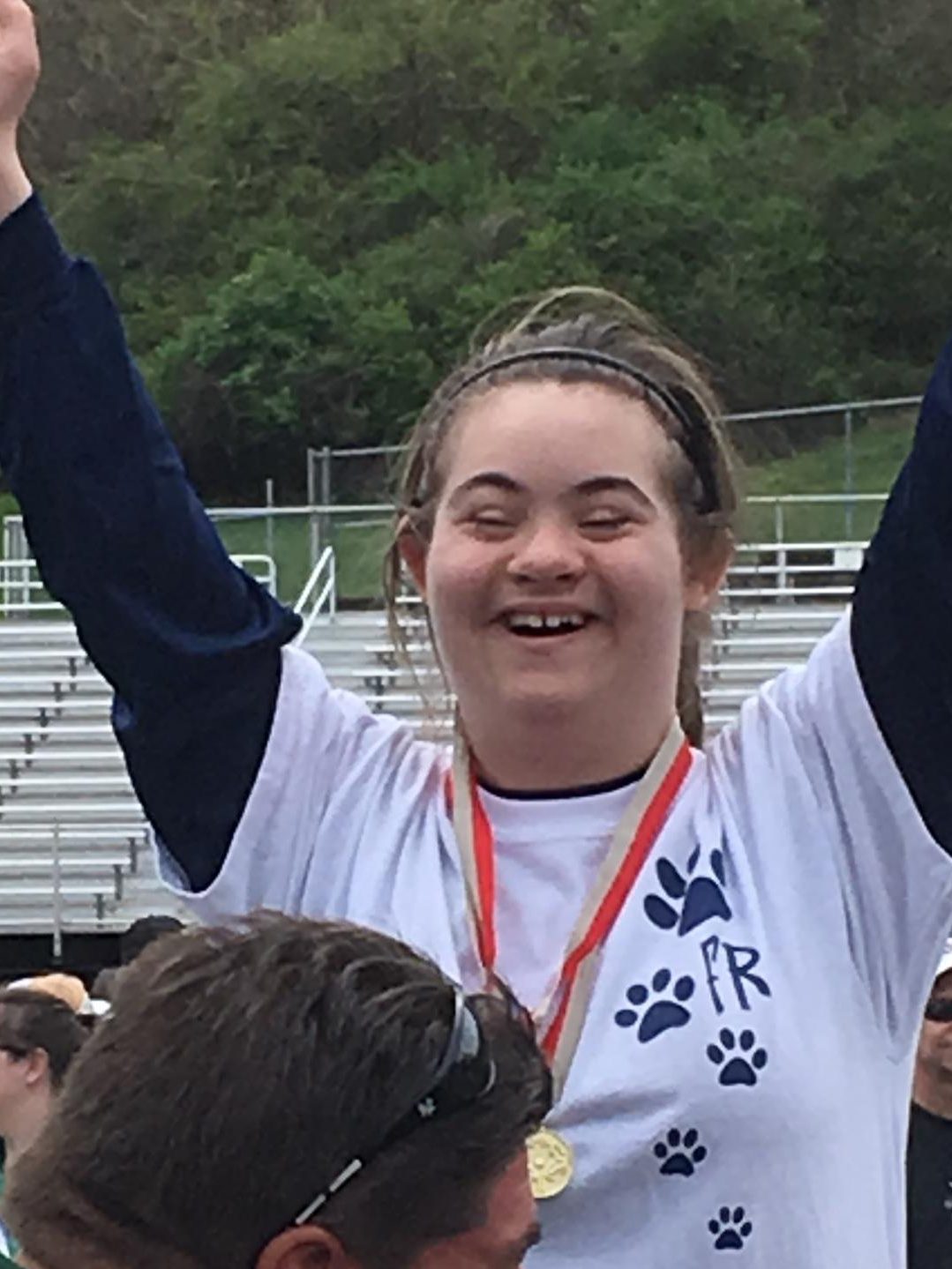 My sister Marina, getting a medal, at Special Olympics