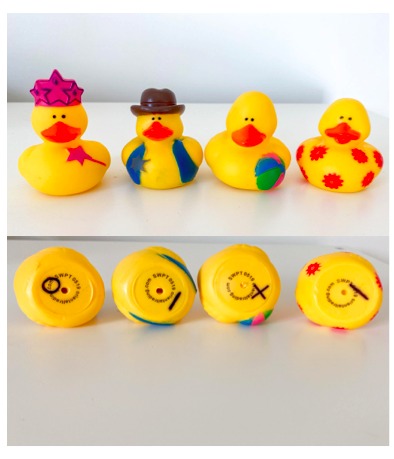 Two sets of rubber ducks with prewriting strokes on the bottom