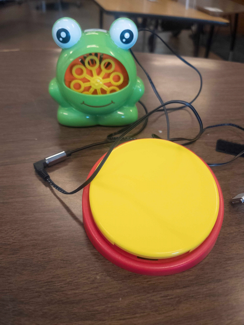 Picture of a wired switch connected to an adapted toy bubble machine.