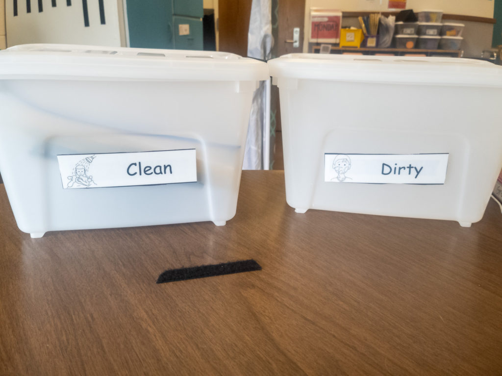 Picture of 2 white containers with lids labeled dirty and clean.