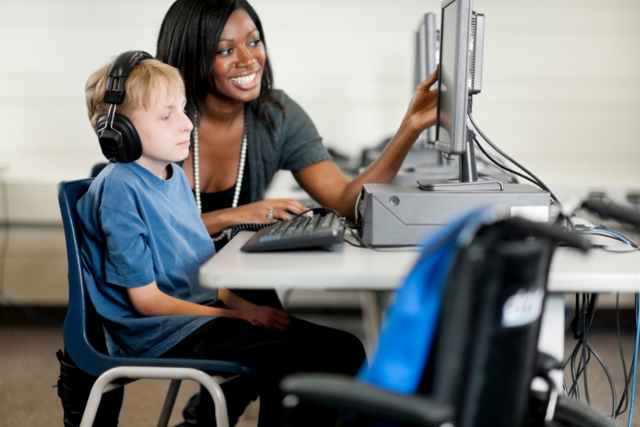 This is a photo of a student using a computer in the classroom. 