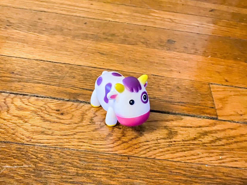 small cow used for play on hardwood floors 