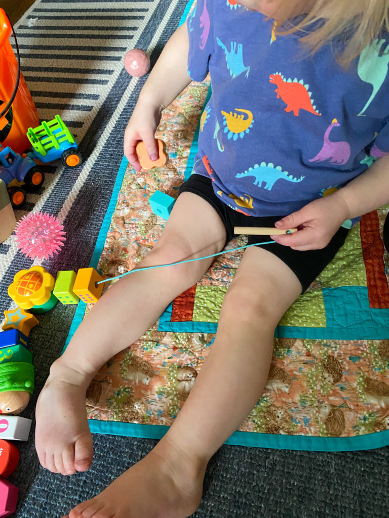 Child sitting with legs stretched forward 