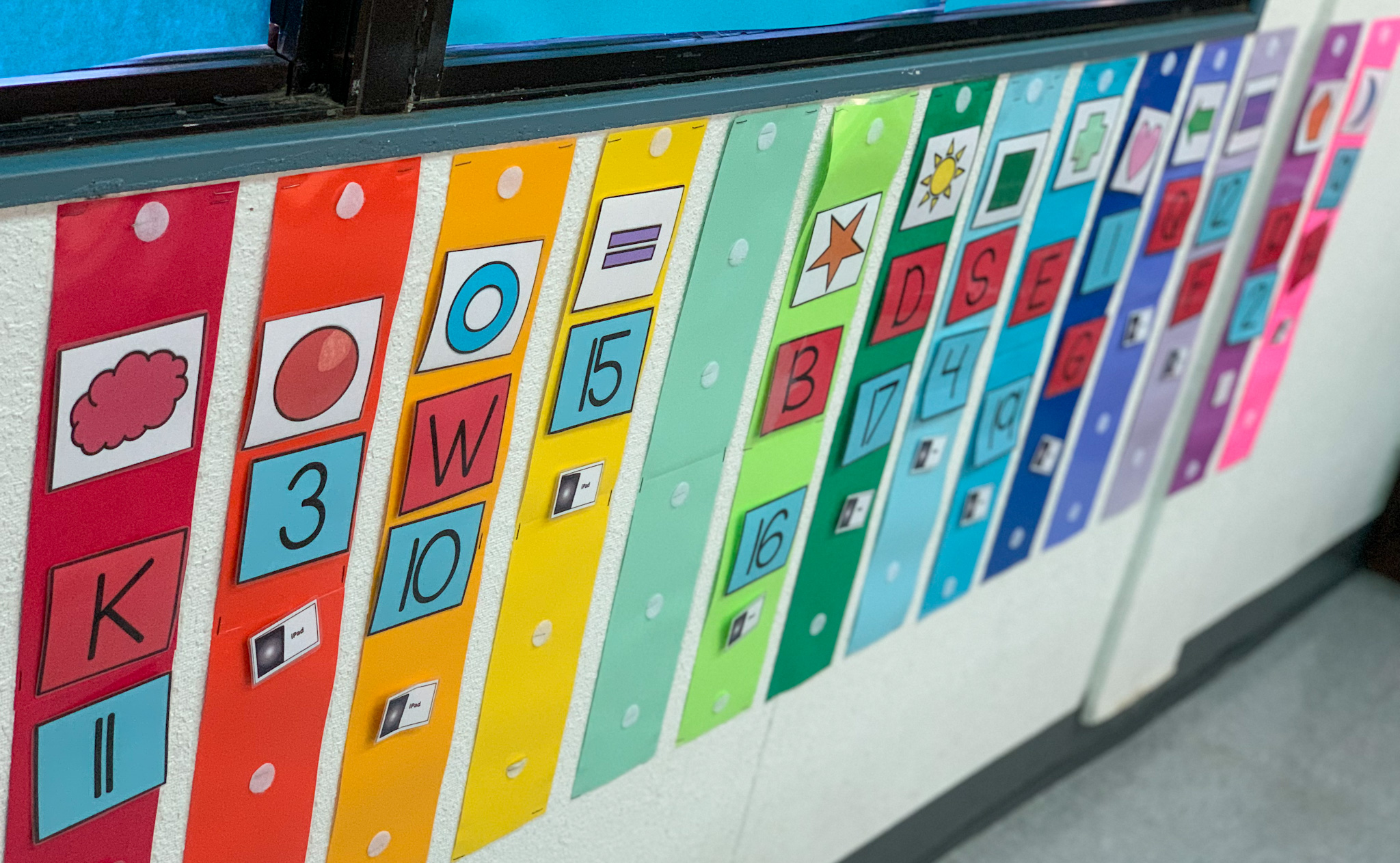 This is a colorful photo of student schedules for my task box center. Each student has their own color and picks the icons off of their wall schedule.