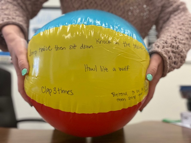 Beach ball with silly directions written on it.