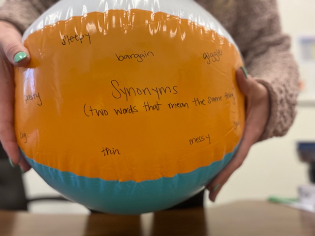 Beach ball with vocabulary words written on it.