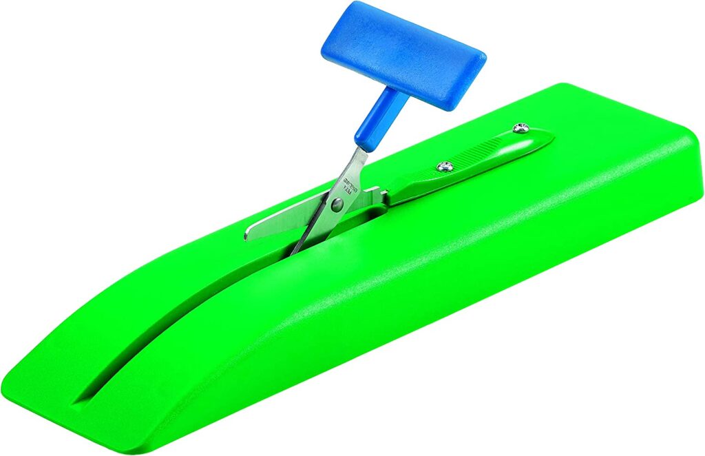 green and blue table top scissors used as equipment in a multiple disabilities classroom