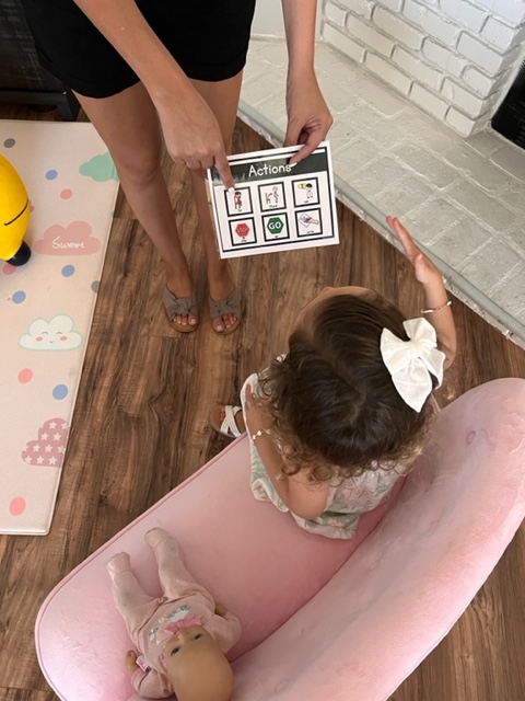 This is a picture of a mom using a communication to get her daughter to sit down. 