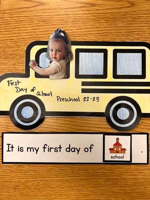 This is a picture of the first day of school bus with a child's picture in the bus. 