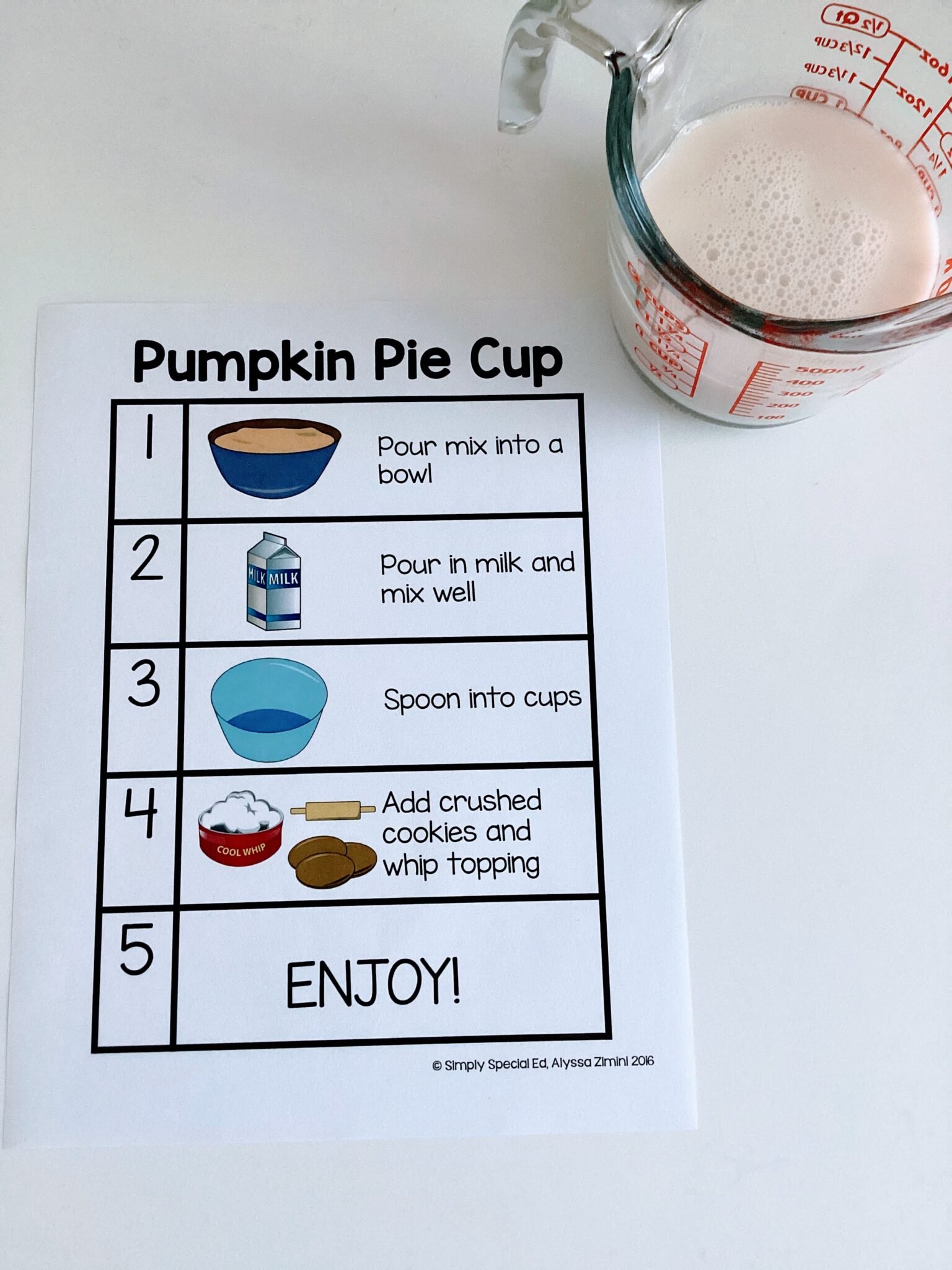 the pumpkin pie cup recipe next to a measuring cup filled with milk