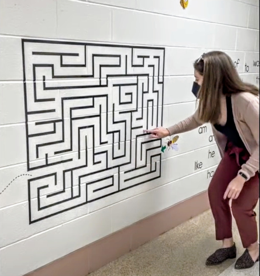 the author navigating a maze on a sensory path with her finger as an idea for a bulletin board