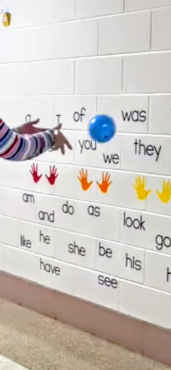 person demonstrates how to modify and activity with the sensory wall by throwing a ball against the push up wall