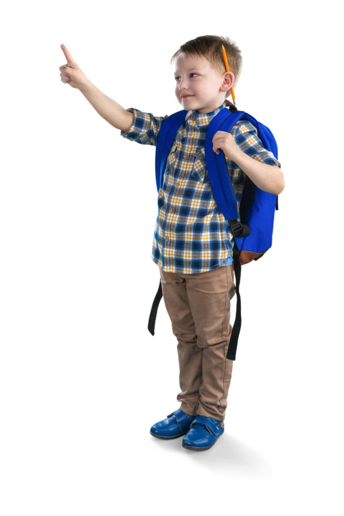 student wearing a backpack with a pencil behind his ear air writes to practice letter formation