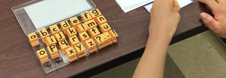 student using lowercase letter stamps to practice multi-sensory letter formation