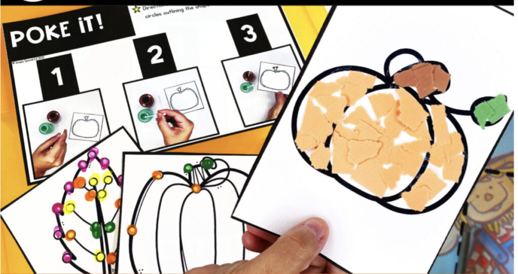 poke it fall fine motor center in the background of a student holding up a pumpkin they made with ripped construction paper as part of the tear it fine motor center 