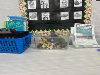 Science center with plastic animals, books and a habitat picture sort. 