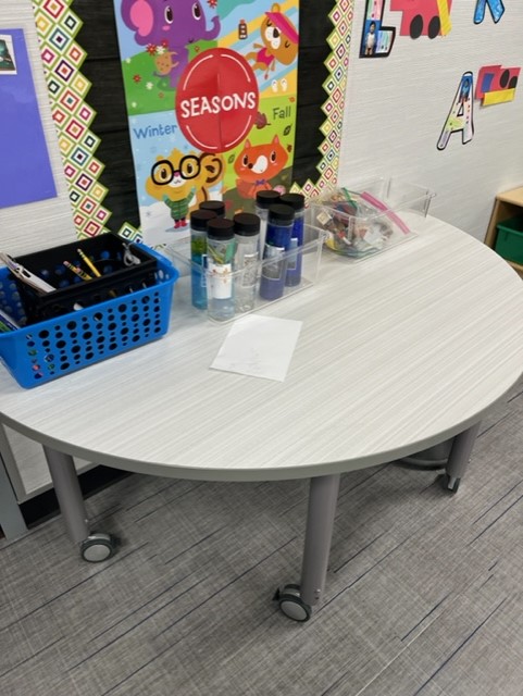 A science table with sensory bottles related to the of the month - weather. 