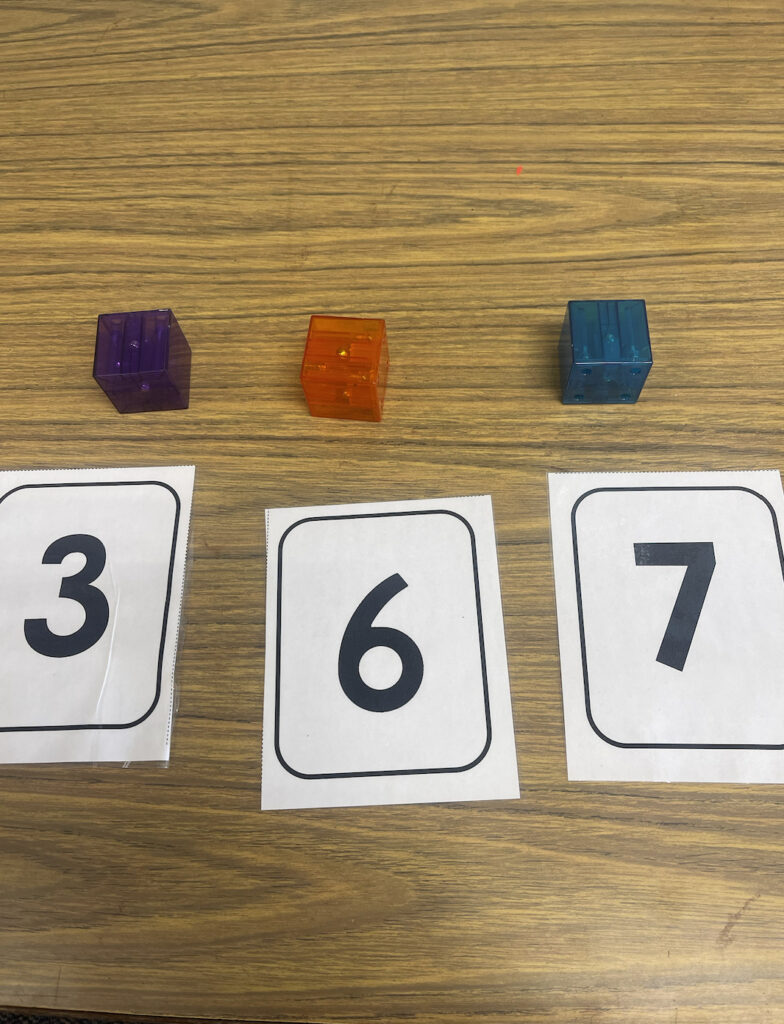 3 different magnet blocks for a student to count, with 3 different flashcards reading the numbers 3, 6 and 7.