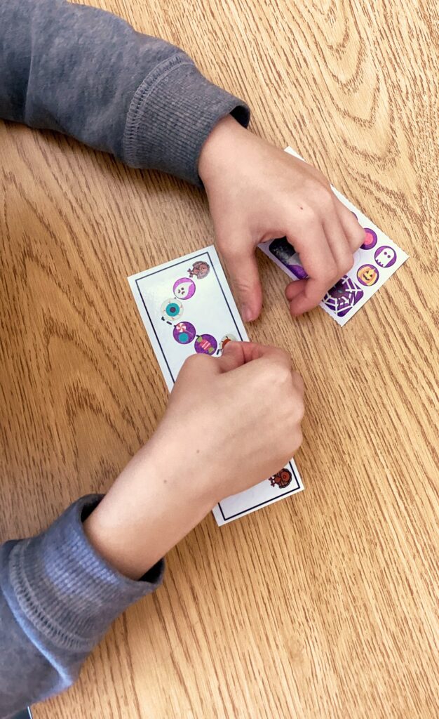 student using the stick it fall fine motor center with Halloween stickers