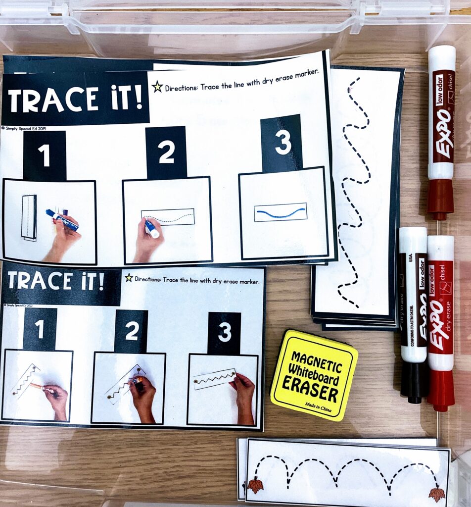 the Trace It Fine Motor Center and the fall version stored together in a bin with dry erase markers and eraser