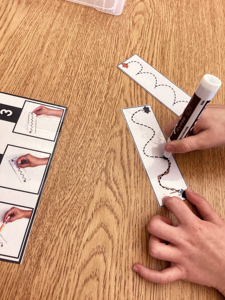 student tracing on one of the Trace It fall fine motor pages