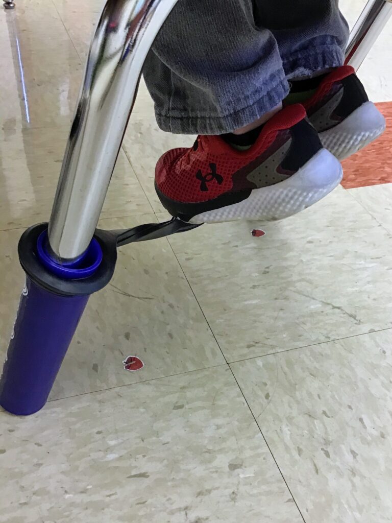 student who is a sensory seeker uses a bouncy band on his chair fo extra movement and input