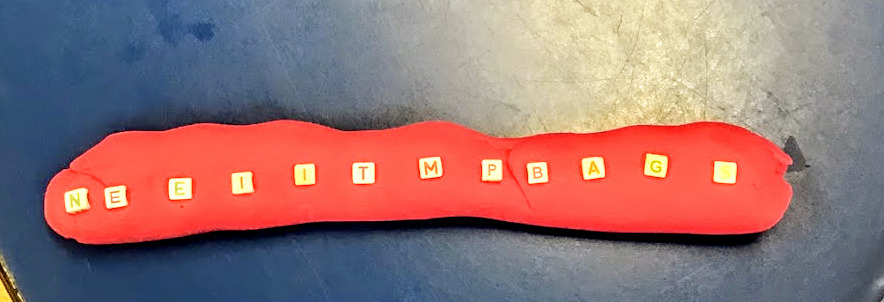 play dough with letter beads in it