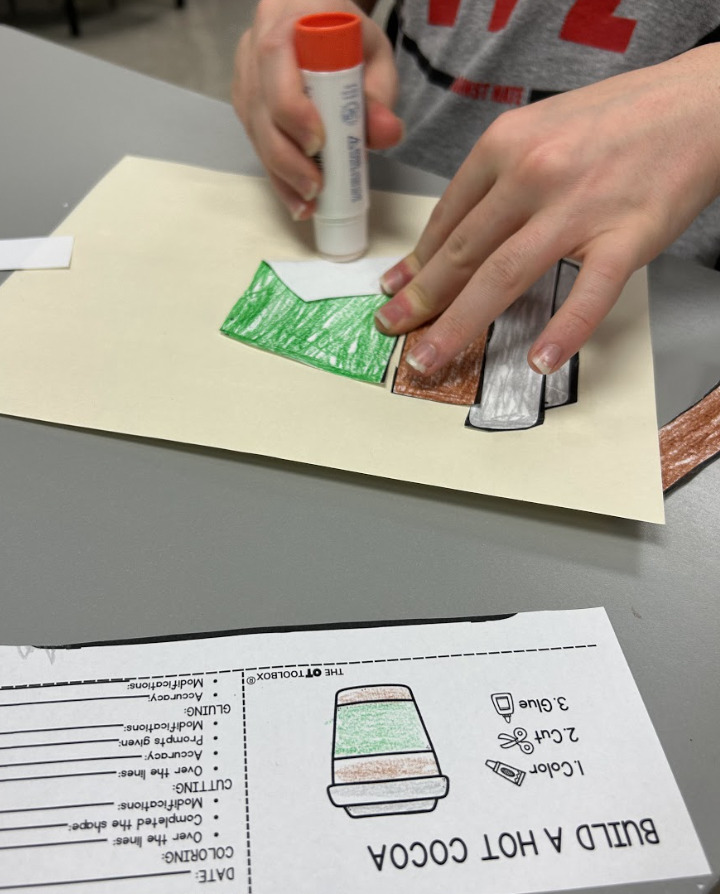 OT student completing a hot chocolate visual craft