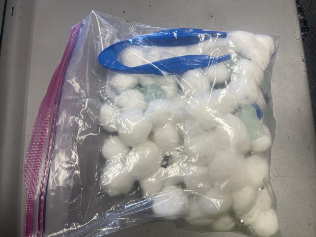 All the cloudy sensory bin materials are placed in a zip loc bag.