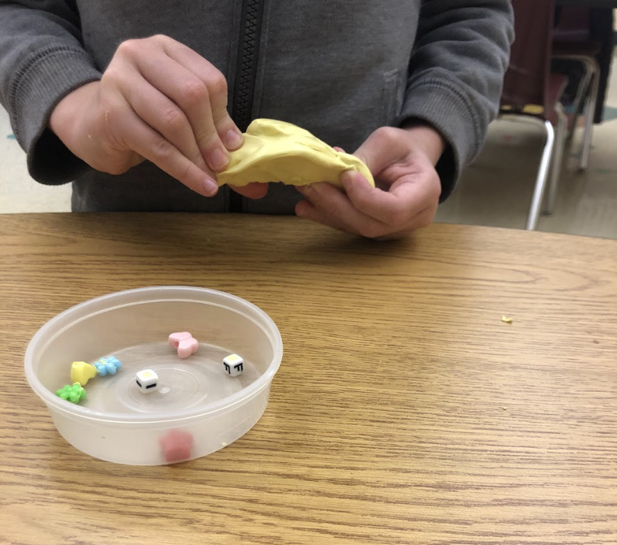 OT student pulling beads out of yellow theraputty similar to what was discussed in the below SOAP note