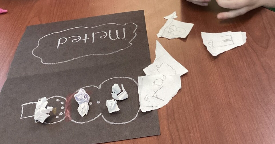 OT student crumpling up paper into small balls after writing on it to fill-in a snowman picture