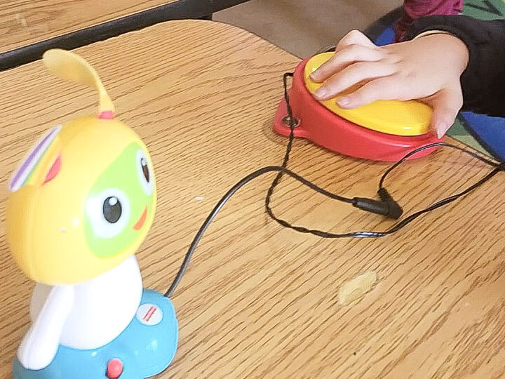 student pressing switch to activate a dancing light up toy