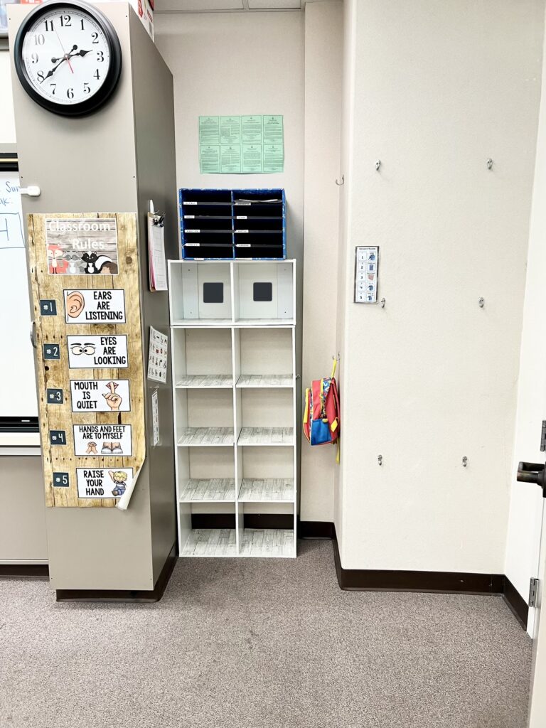 Student cubbies for lunches, hooks for backpacks and classroom rules.