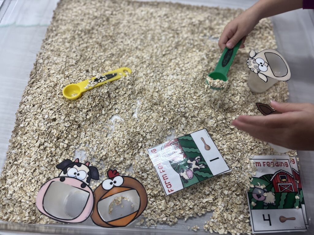 Farm themed sensory bin encouraging counting, measuring and language. 