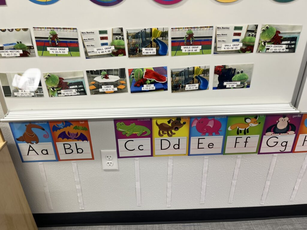 Sample Preschool classroom schedule on the white board. They're held up by magnetic tape