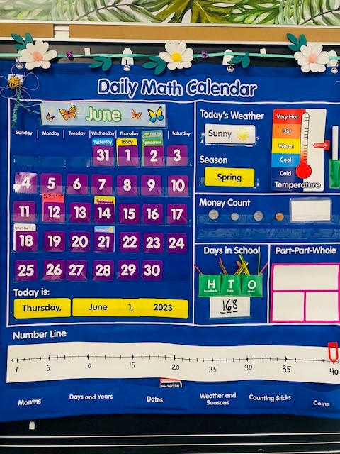 Blue morning meeting math calendar displaying the month of June with purple numbers