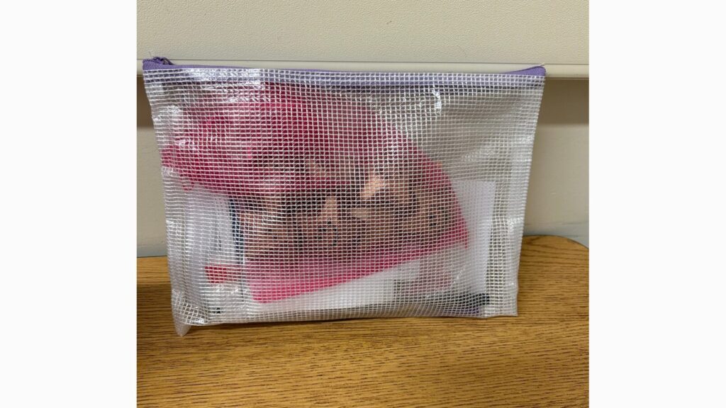 Image of a mesh zipper pouch holding incentives for a student