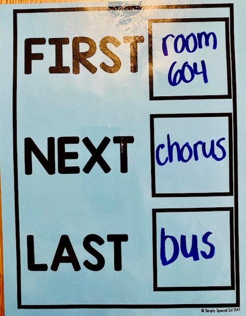 A blue laminated paper that says first go to room 604, next chorus, last bus