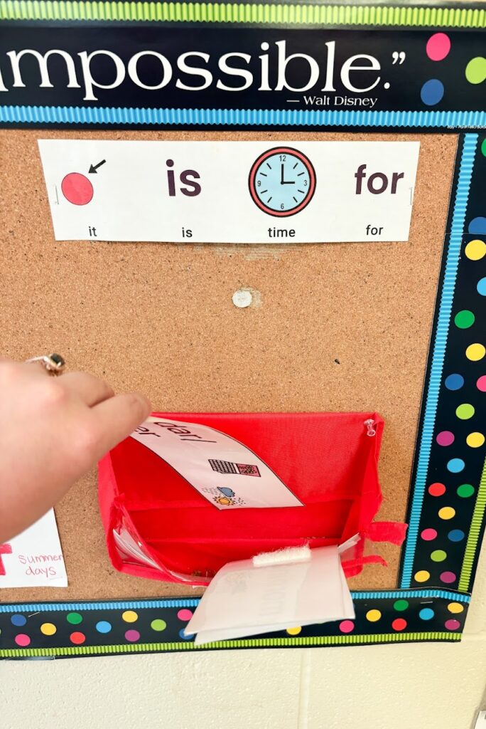 hand placing visual schedule piece in all done basket