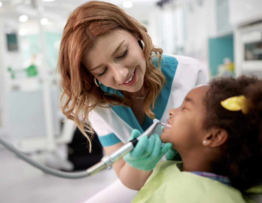 dentist checking a child's teeth