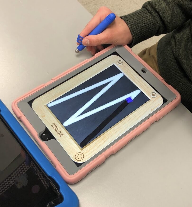 student using the Handwriting Without Tears Wet Dry Try app on an iPad with a Write Right stylus