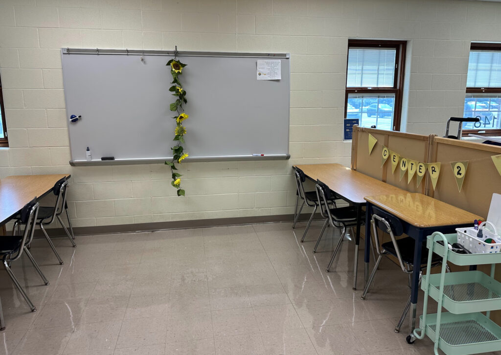 Photo of center areas with tables, chairs, and supply caddies.