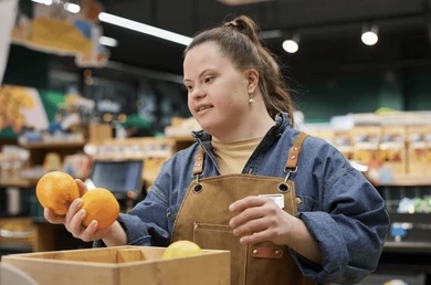 Teenage with disabilities at work stocking shelves