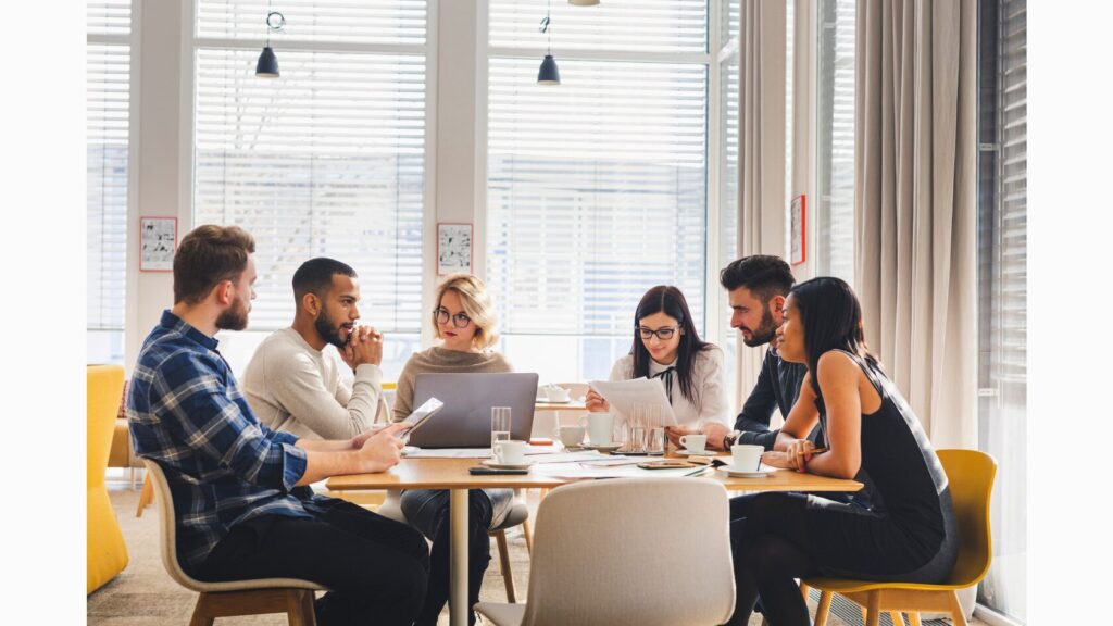 Image of a team of six adults conferencing.