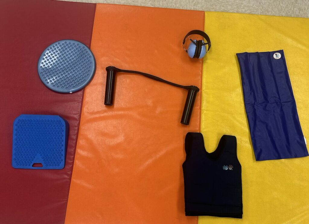 Sit Fit cushion, wedge seat cushion, Bouncy Band, noise dampening headphones, weighted lap pad and weighted vest
